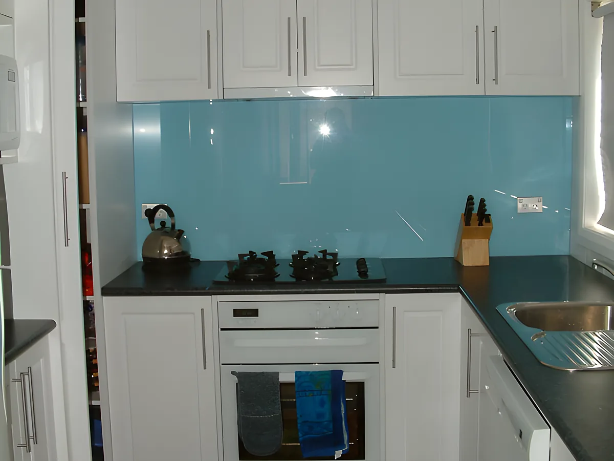 Kitchen with back painted aqua glass backsplash